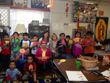 Students participate at the bilingual story hour with Hispanic children at La Casa Amiga